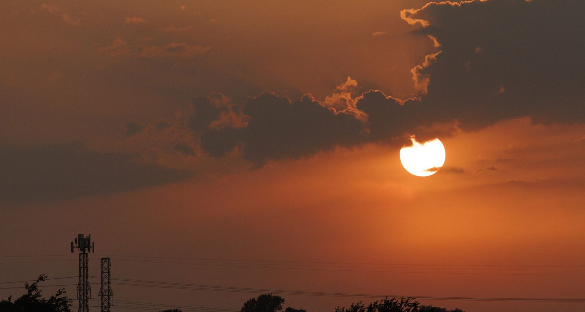 The sun sets behind clouds after a series of tornado-warned storms moved across North Texas on Tuesday, April 28, 2026, in Fort Worth.