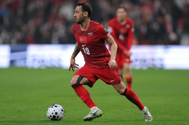 Hakan Calhanoglu controls the ball 