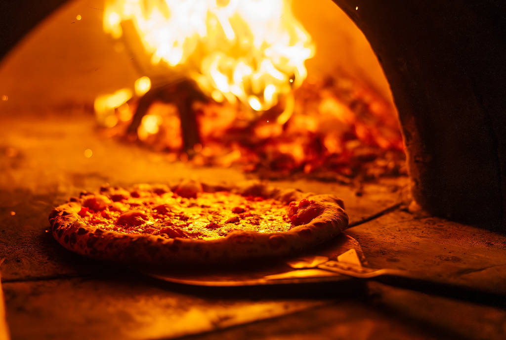 Image shows a pizza in an oven.