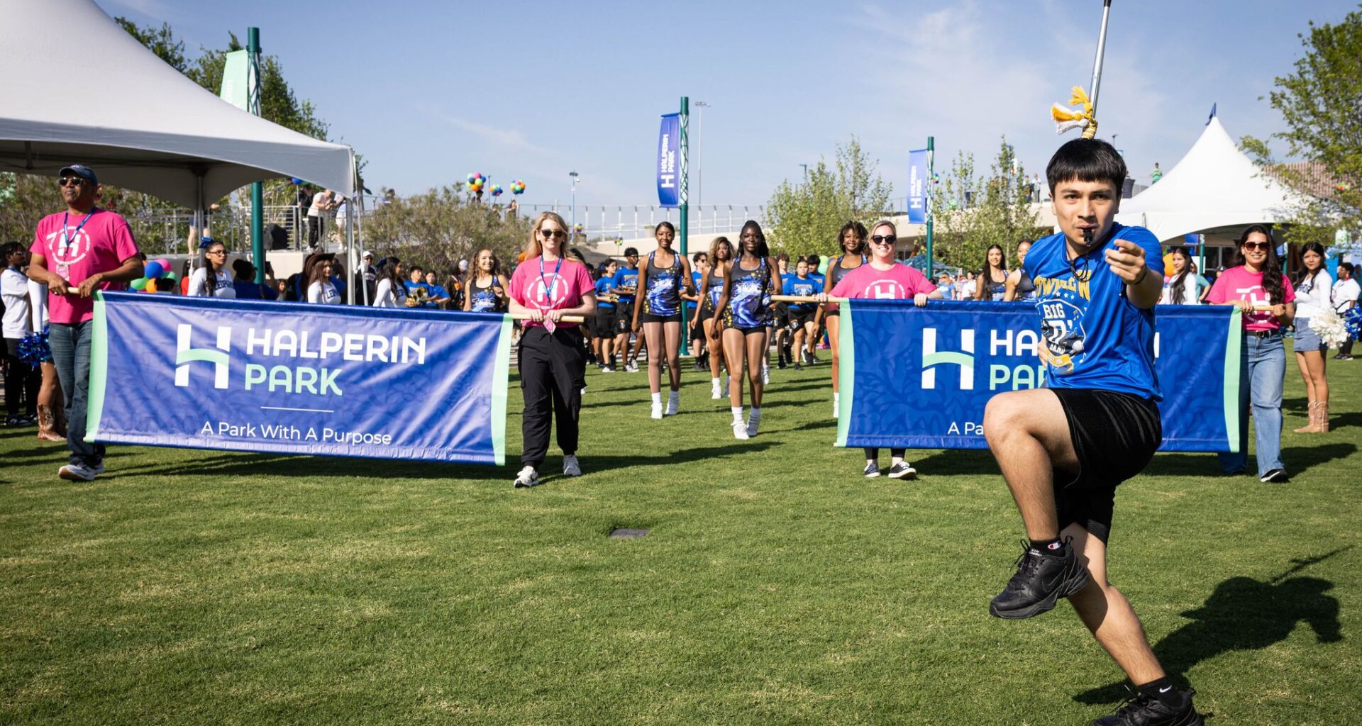 The Townview marching band parade across the lawn during opening celebration for Halperin Park, Oak Cliff’s new deck park in Dallas, Saturday, May 9, 2026. The band shell is seen in the background.