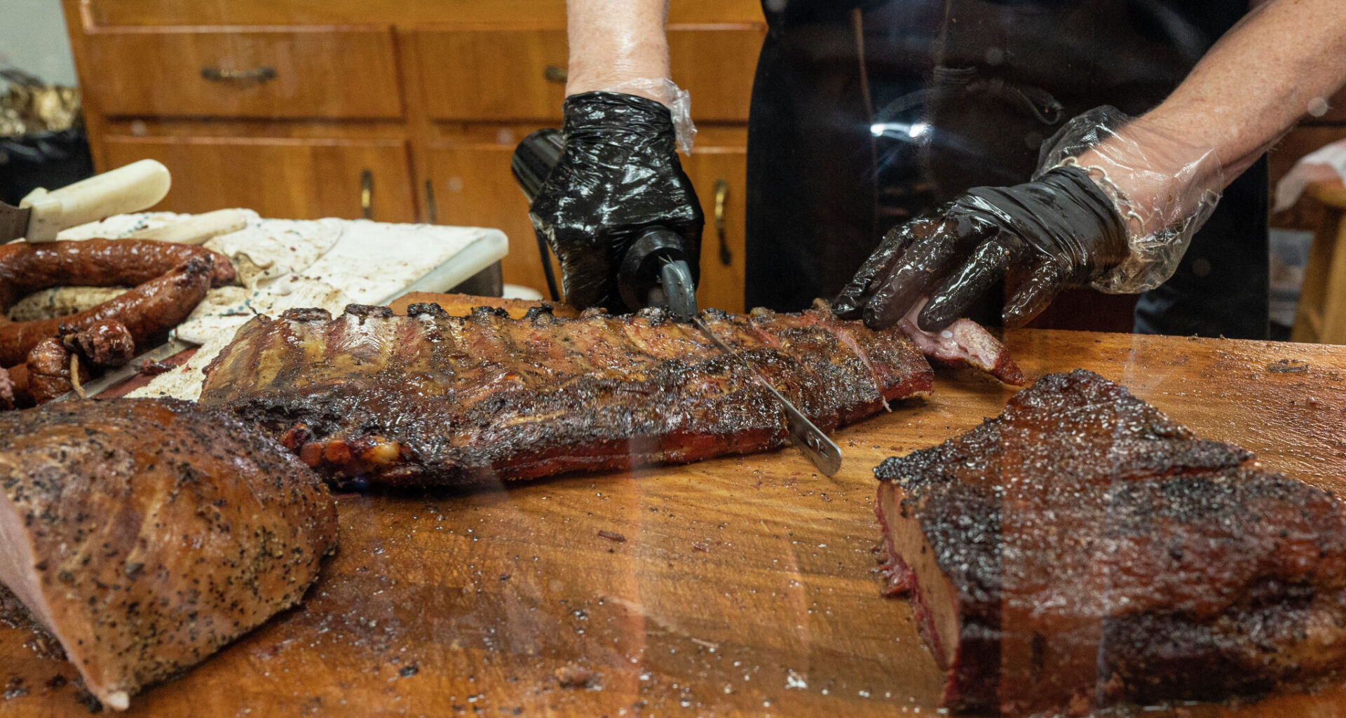 Pork ribs are sliced with an electric knife at Snow's BBQ on July 31, 2021 in Lexington, Texas.