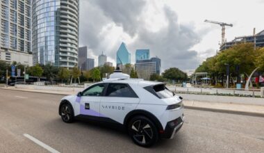 An Avride autonomous vehicle, part of Uber's robotaxi fleet, is pictured driving by Klyde Warren Park in Downtown Dallas. On Dec. 3, 2025, Uber launched autonomous robotaxi rides in Dallas through Avride.