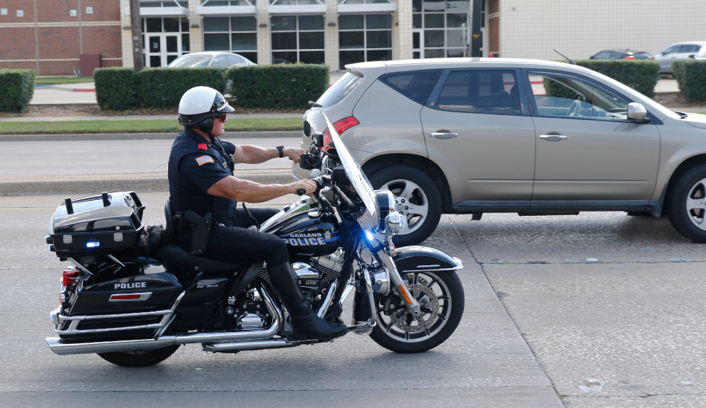 Garland police Officer Lanny Orman chases a motorist for texting on his phone while driving through a school zone at Handley Elementary.
