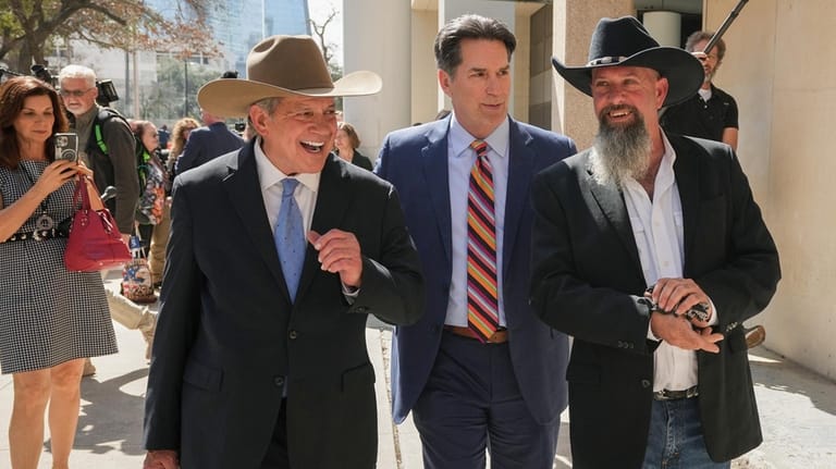 Forrest Welborn, right, leaves the courthouse with his attorney, Steve...