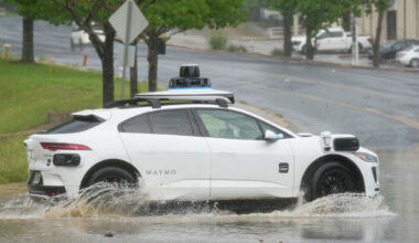 A Waymo autonomous vehicle goes through standing water on Metro Center Drive after a brief, intense rainstorm April 30 in Austin.