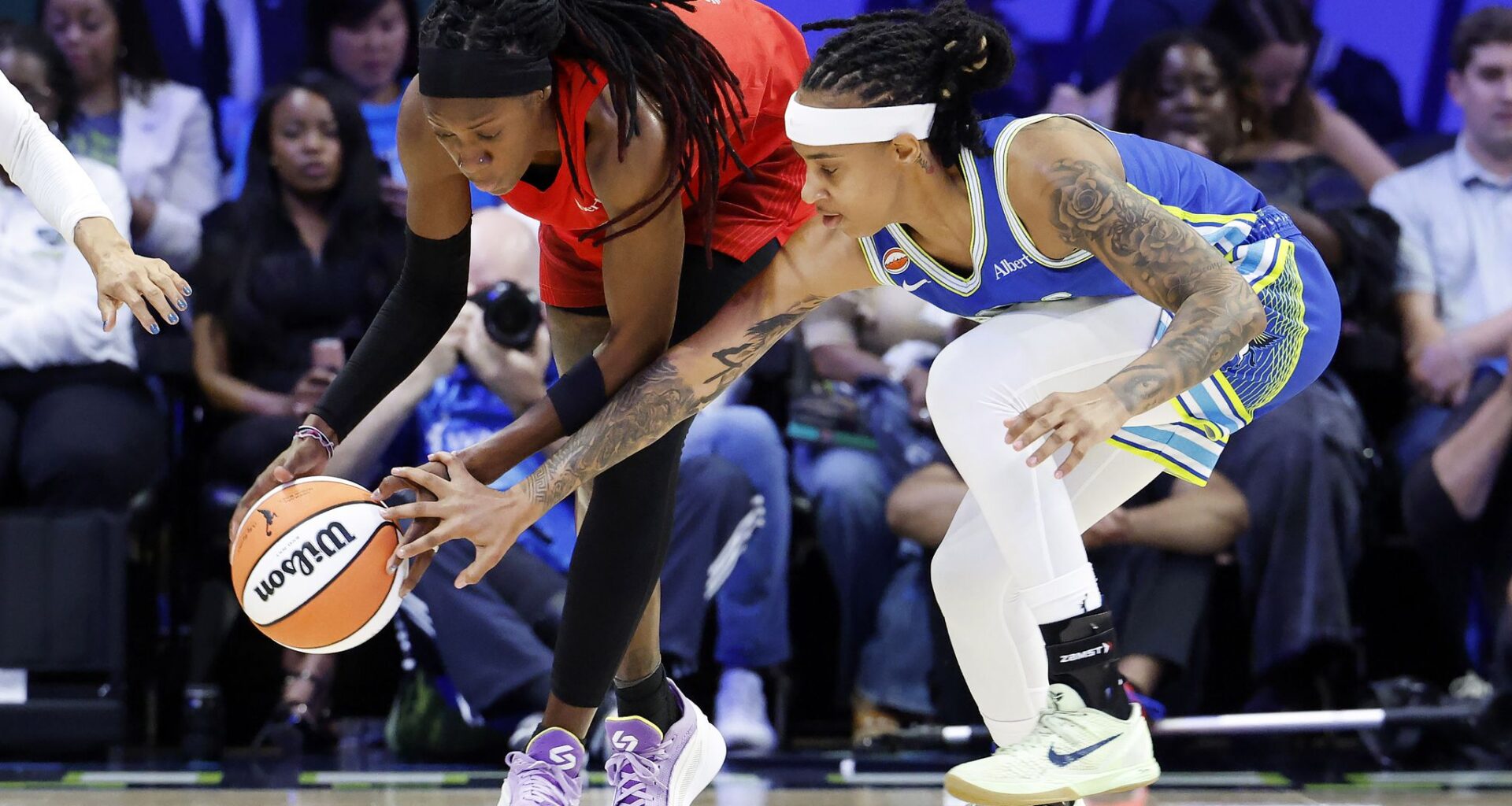 Dallas Wings rookie Azzi Fudd (second from right) watches from the bench in street clothes as her teammates faced the Atlanta Dream in the first half at College Park Center in Arlington, May 12, 2026.