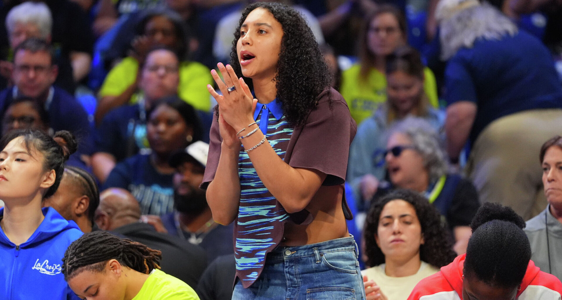 An injured Dallas Wings guard Azzi Fudd cheers from the bench during the first half of a WNBA basketball game against the Atlanta Dream in Arlington, Texas, Tuesday, May 12, 2026. (AP Photo/LM Otero)