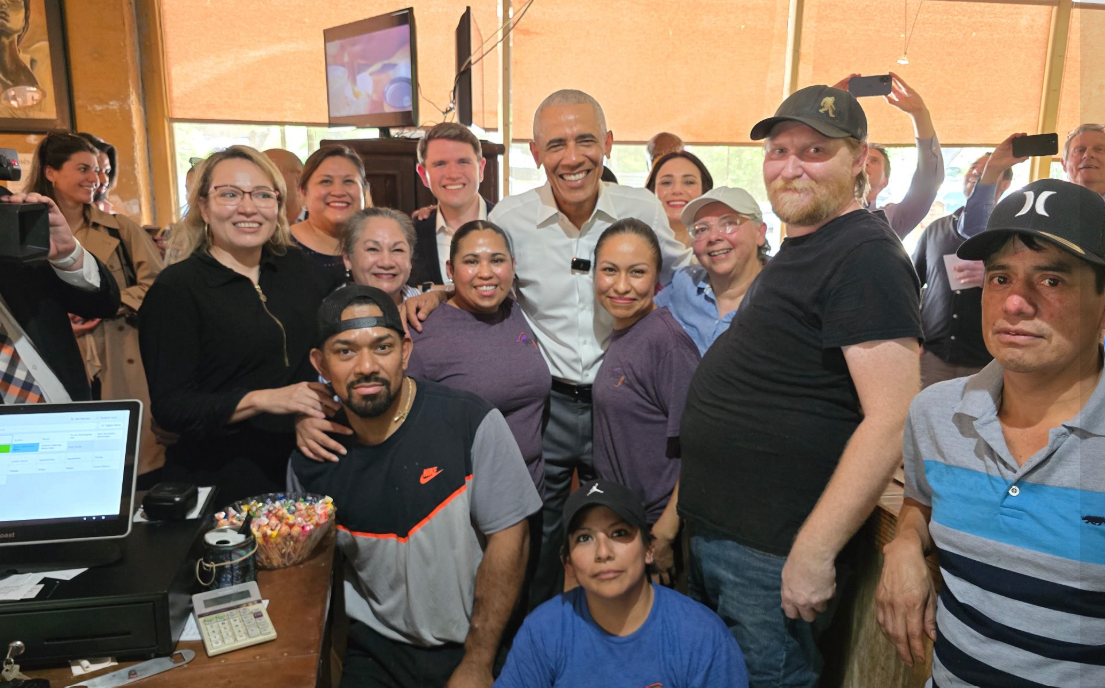 Former U.S. President Barack Obama alongside Texas Democrats James Talarico and Gino Hinojosa pose for a photo with Taco Joint staff in Austin, Texas.