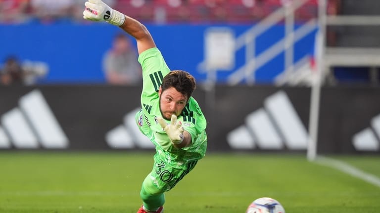 FC Dallas goalkeeper Michael Collodi reaches for a shot on...