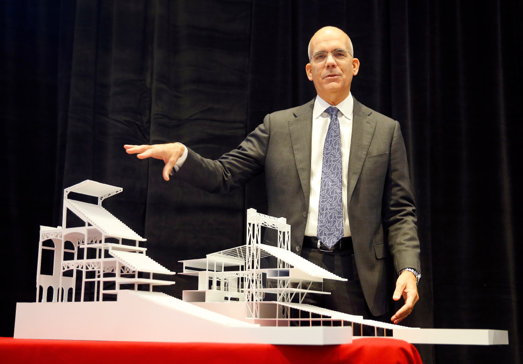 HKS executive vice president, director of sports & entertainment Bryan Trubey points to models of what the new Texas Rangers ballpark seating will look like when designed. The difference between the new (left) and existing (right) seating structure is that the seating configuration gives the fan a more intimate feel to the game by putting them closer to the field. The Texas Rangers baseball organization announced that HKS has been selected to design the new ballpark adjacent to Globe Life Park during a press conference in Arlington, Thursday, January 5, 2017.
