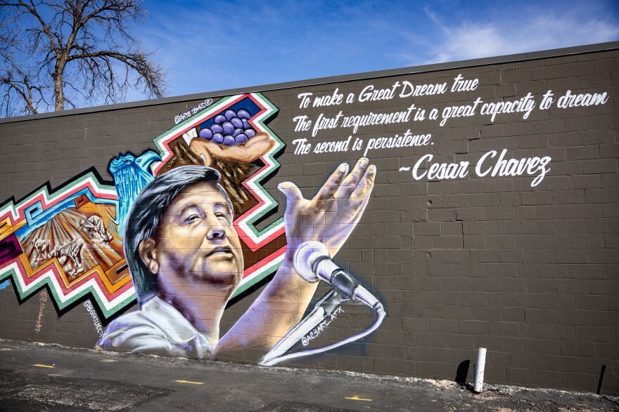 A mural of Cesar Chavez is shown on a wall.