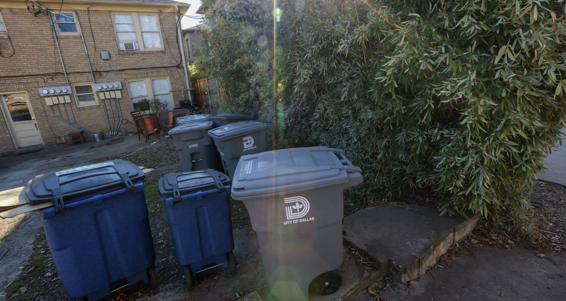 Trash and recycling bins sit in an alleyway of Hawthorne Avenue in Dallas on Wednesday, Jan. 4, 2023.