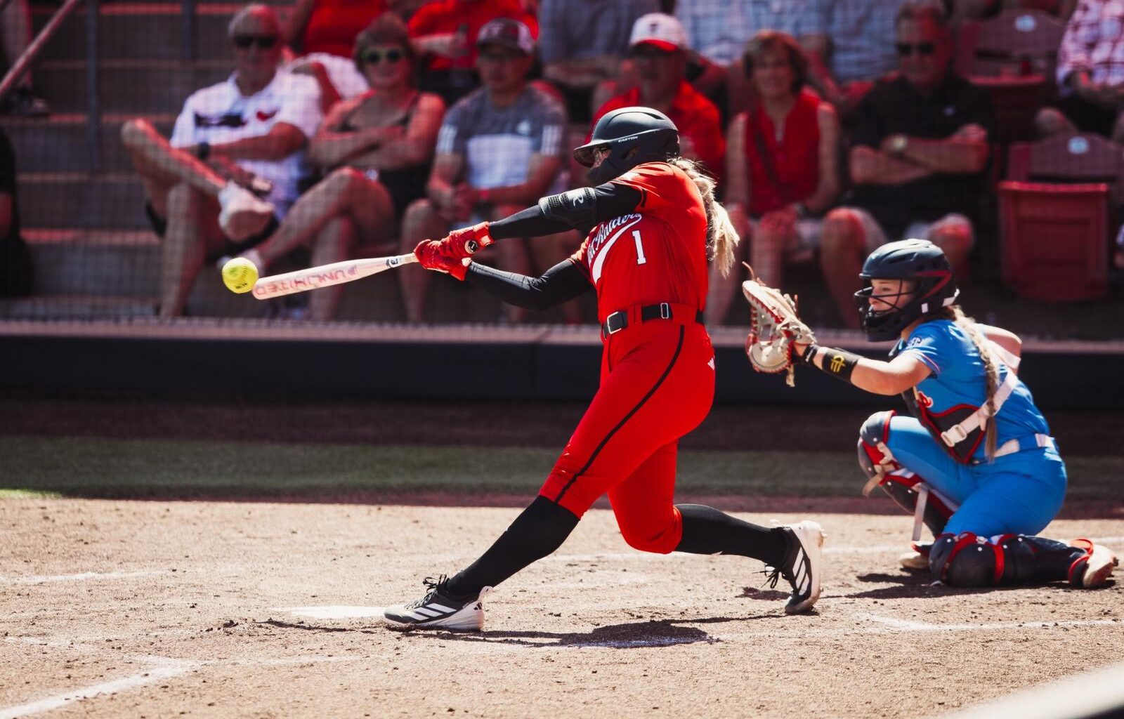 Jackie Lis clapping at first base after driving in a run against Ole Miss