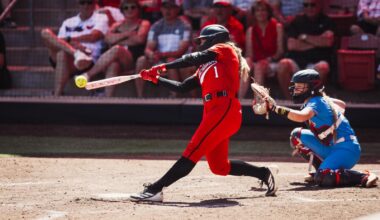 Jackie Lis clapping at first base after driving in a run against Ole Miss