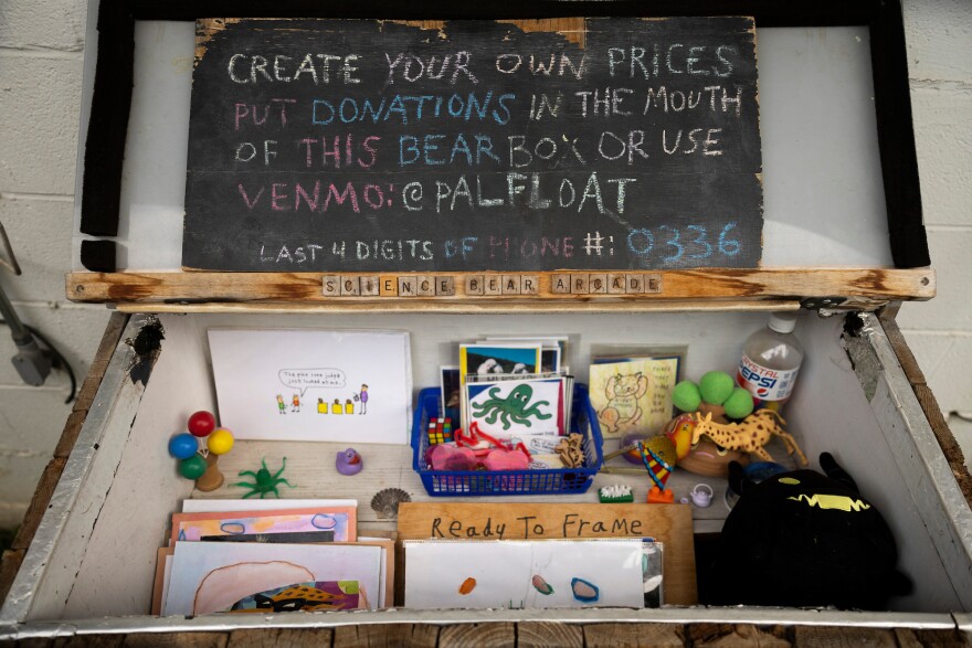 Pieces of artwork and collectibles sit in a bear box at Collection Rert in Austin, Texas, on May 16, 2026. Lorianne Willett/KUT News