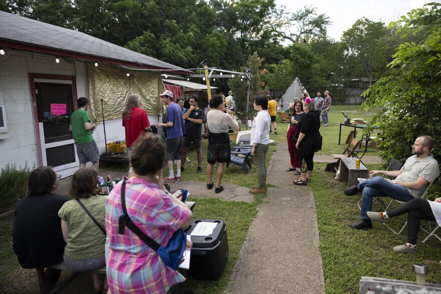 People gather outside a home at a party.