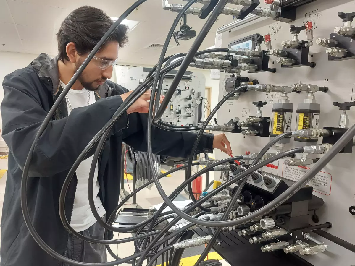 Dylan Ruiz, a 17-year-old senior at Legacy High School in Midland, works through a training scenario on preventing oil leaks during his class on pumps, compressors and mechanical drives at Midland College's Petroleum Energy Program.