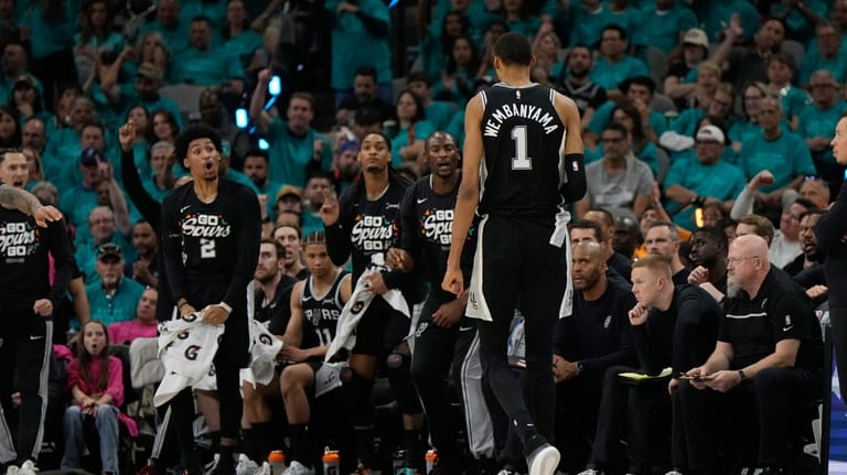 San Antonio Spurs forward Victor Wembanyama (1) walks toward the...