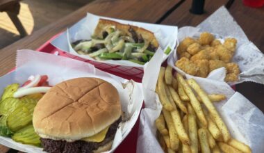 A spread featuring a cheeseburger, Texas cheesesteak, fries and tater tots at Lone Star Float House &amp; Grill on May 16, 2026 in New Braunfels, Texas.