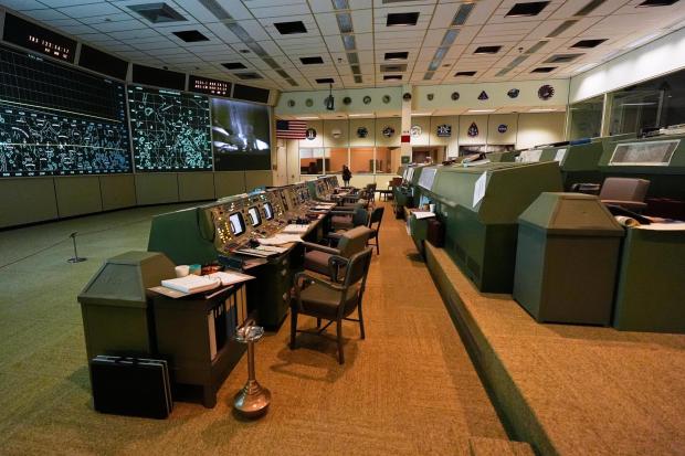 Artifacts sit in the Apollo Mission Control room at Johnson Space Center 