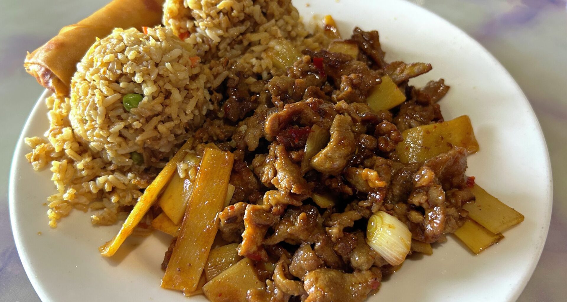 Sichuan beef with fried rice and an egg roll from Gin Chinese Restaurant.