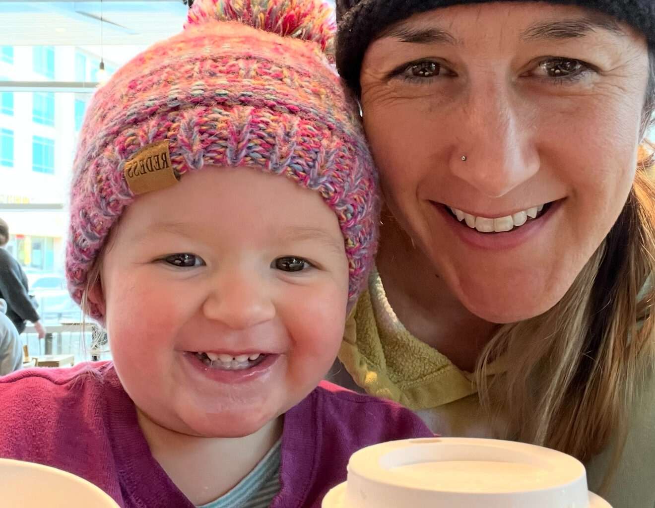 Naima Hill smiles with her daughter, Aveline "Avy" Hill, during coffe shop outing. Avy was 22 months old when she was killed in a car crash near Wichita Falls in 2023. 