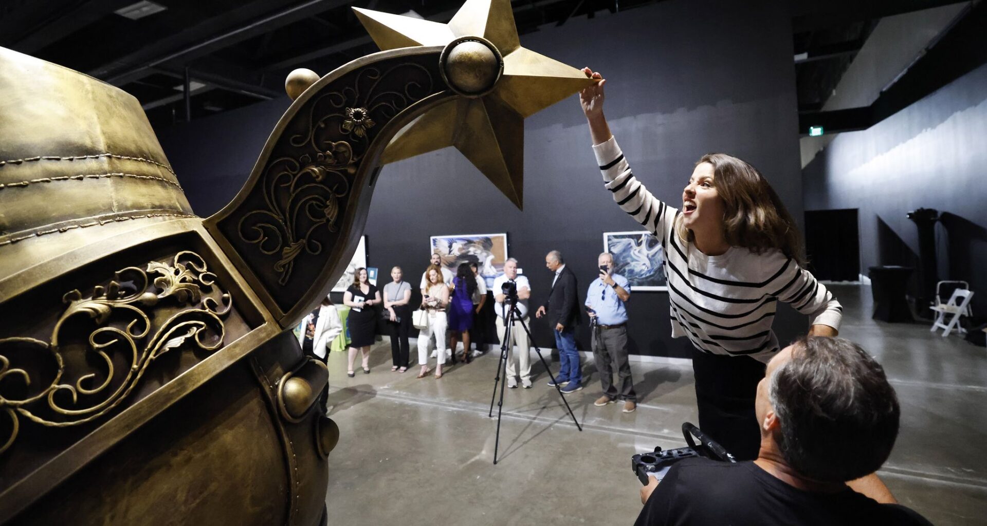 Arlington councilwoman Brittney Garcia-Dumas gives the Lone Star spur a spin after it was welded into place during an VIP unveiling at the Arlington Museum of Art, May 26, 2026. In advance of the FIFA World Cup, artist Steve Ekpenesi of Lagos, Nigeria created the ‘Texan Golden Boot" sculpture, a public art landmark to be erected in the Arlington Entertainment District.