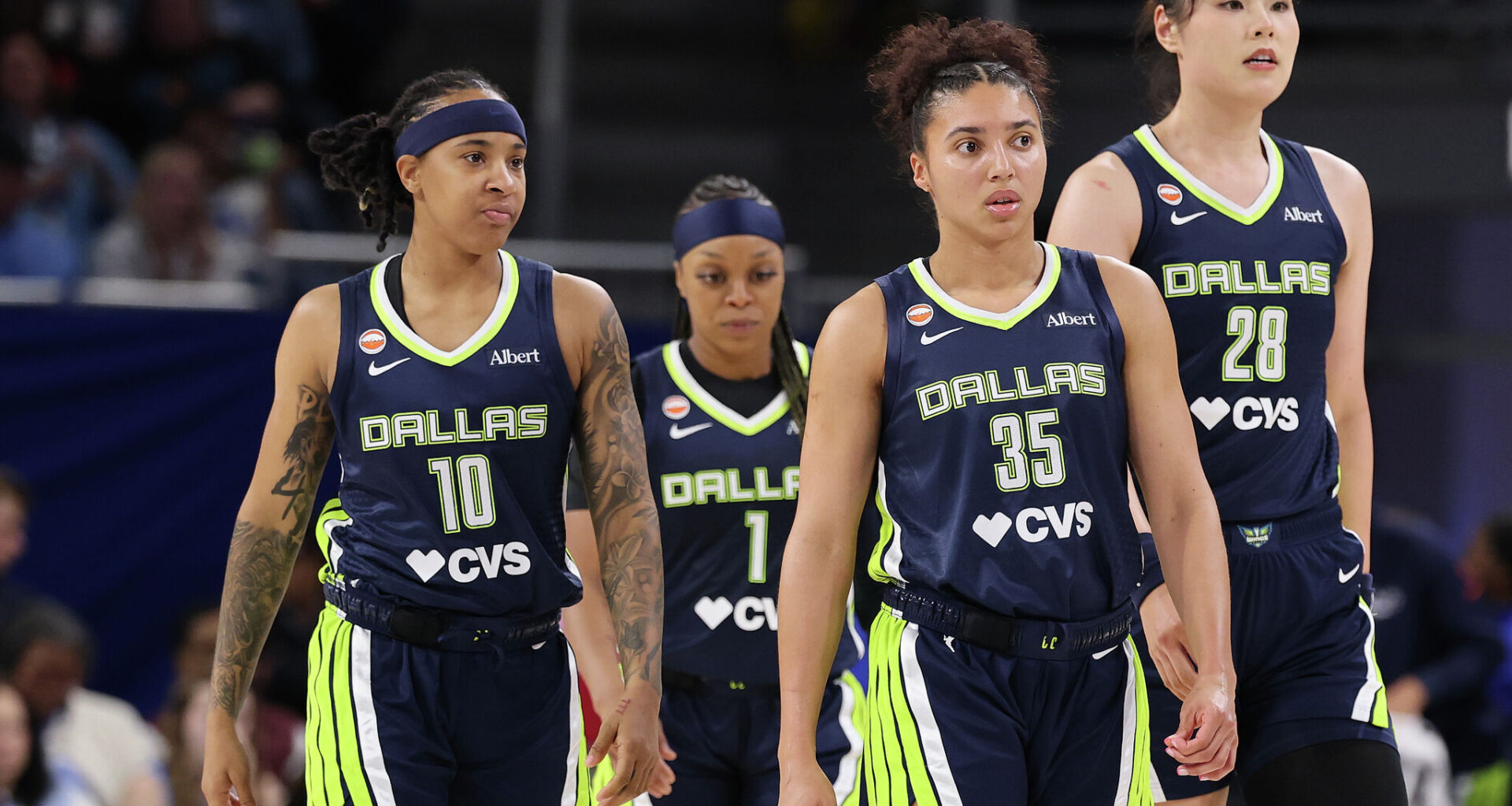 CHICAGO, ILLINOIS - MAY 20: Aziaha James #10, Odyssey Sims #1, Azzi Fudd #35 and Li Yueru #28 of the Dallas Wings look on against the Chicago Sky during the second half at Wintrust Arena.