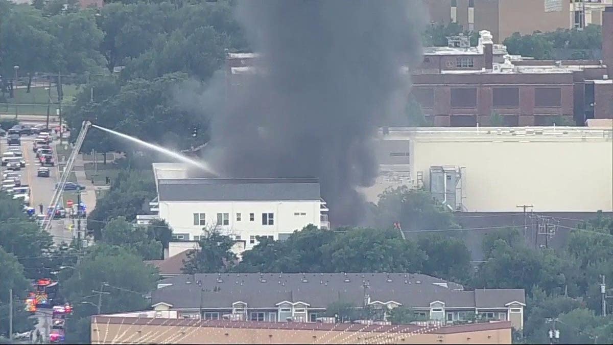 Black smoke rises into he sky