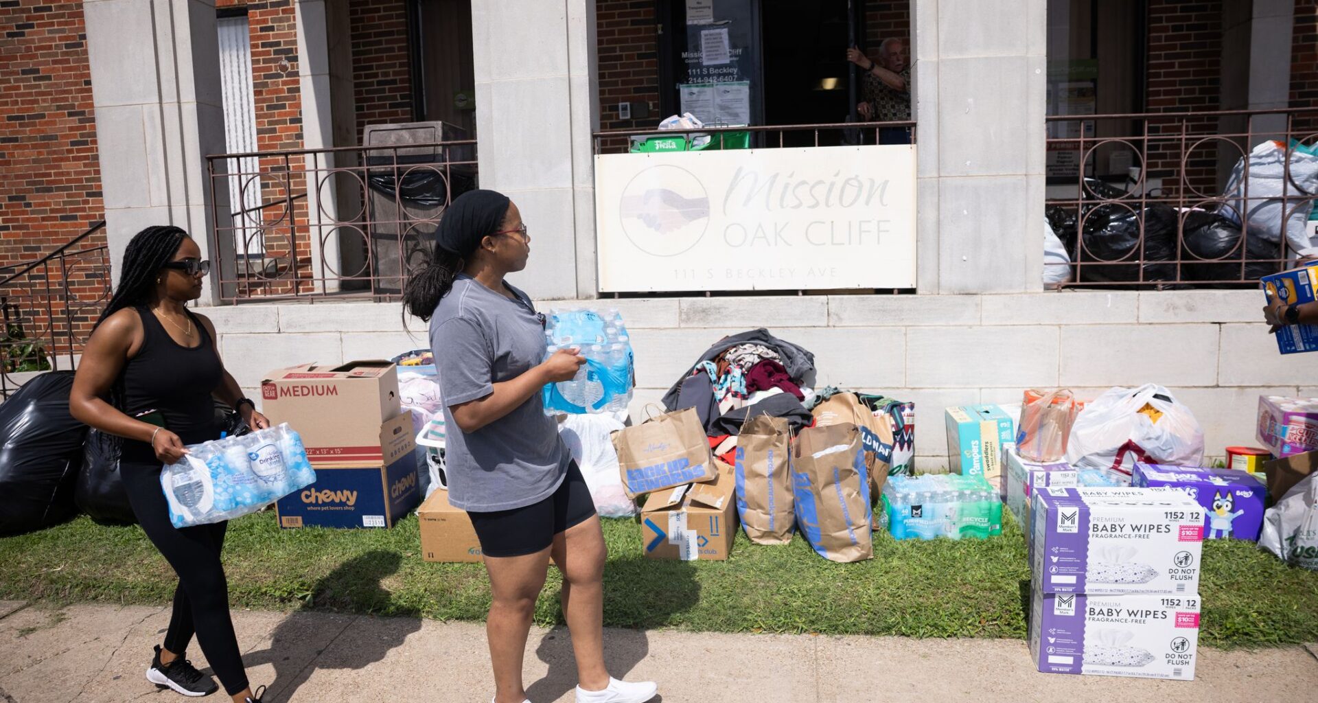 People drop off water bottles at Mission Oak Cliff in Dallas, Friday, May 29, 2026. Officials said at least three people died and several were injured after an explosion at an apartment building in north Oak Cliff on Thursday.