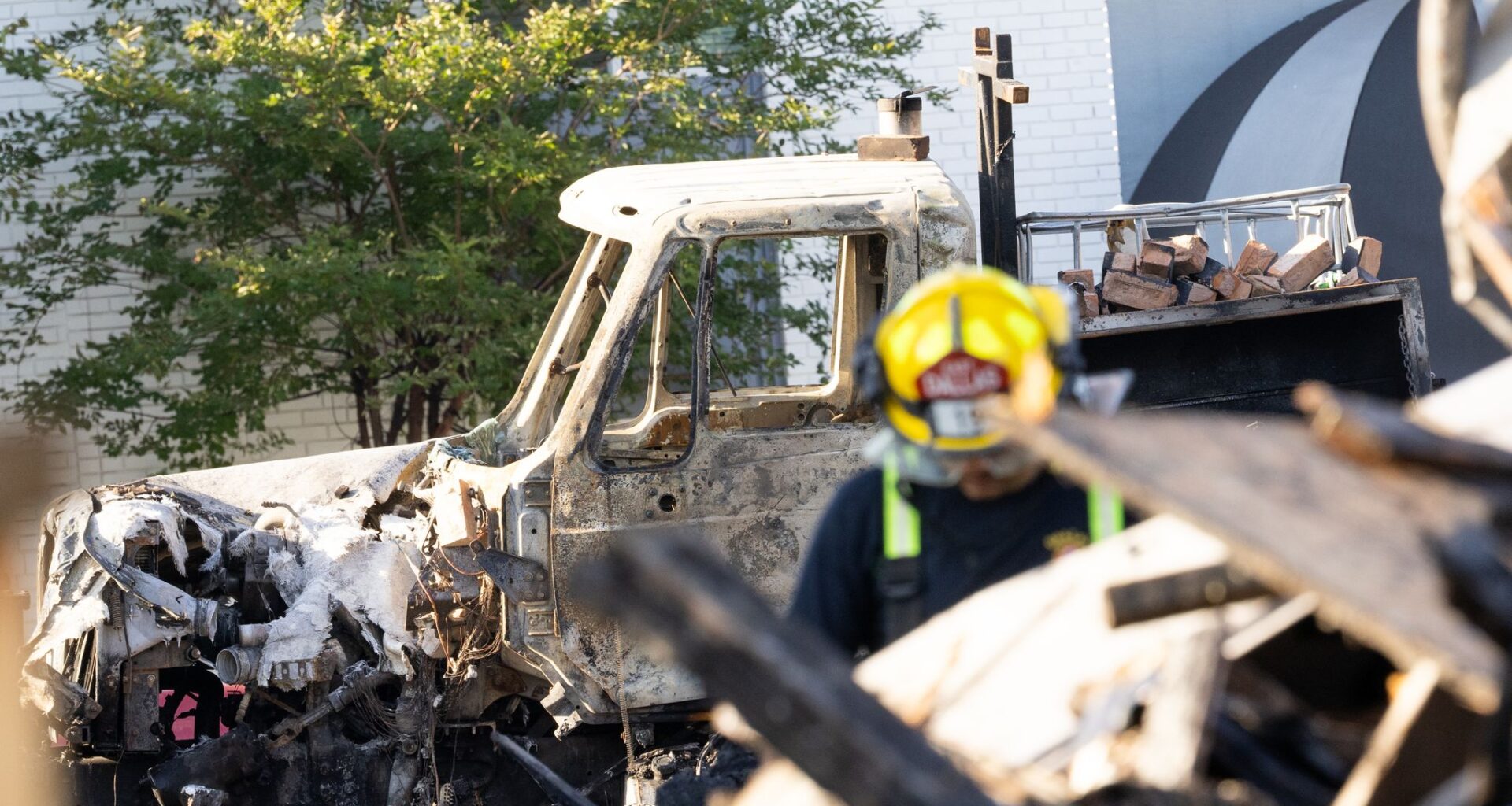 A damaged truck seen as Dallas Fire-Rescue comb through the debris of a collapsed apartment complex in the 400 block of east 9th Street in Oak Cliff in Dallas, Friday, May 29, 2026. Officials said at least three people died and several were injured after an explosion at an apartment building in north Oak Cliff on Thursday.