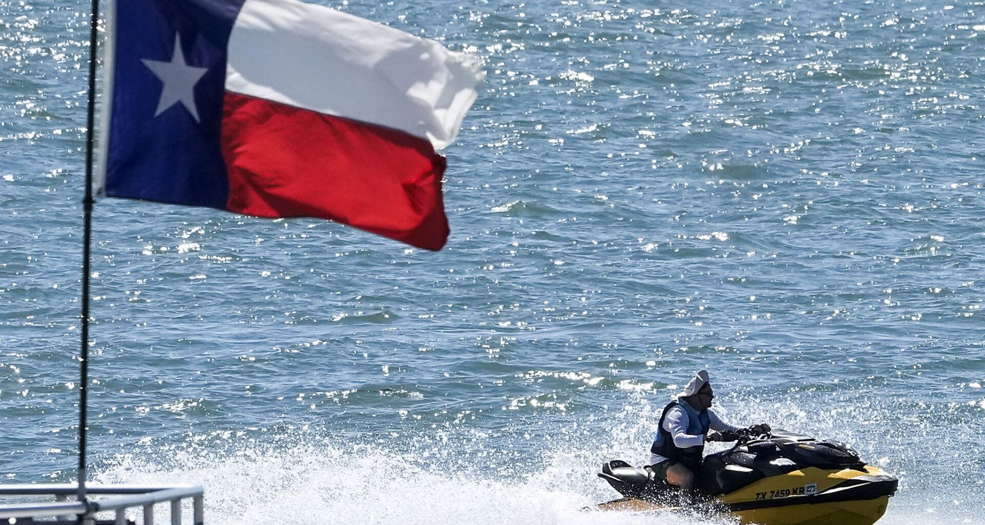 A personal watercraft plies the waters of Lake Ray Hubbard, Sunday, May 3, 2026. Sunday’s forecast called for warm and humid day with temperatures topping out near 96. 