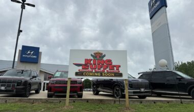"Coming Soon" signage outside a New Braunfels car dealership along I-35 on May 27, 2026, where state filings and new signage indicate a planned conversion into King Buffet, an all-you-can-eat Asian restaurant concept.