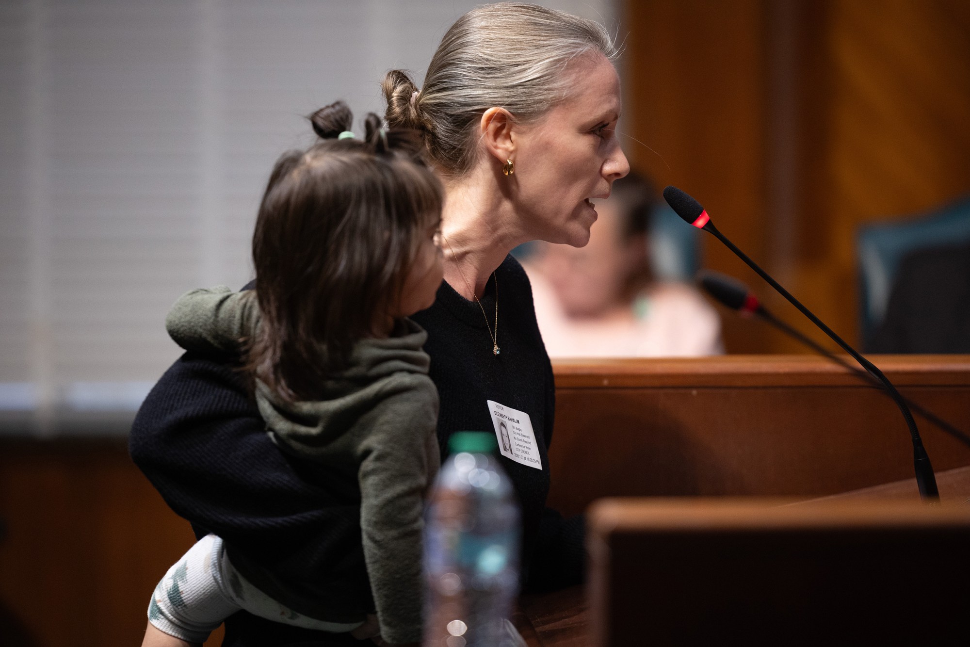 Elizabeth Bahalim holds her daughter Amina, 1, as she voices her frustration with Houston’s collaboration with ICE during a Houston City Council meeting, Tuesday, Jan. 27, 2026, in Houston. A majority of attending speakers spoke about Houston’s collaboration with ICE enforcement. The night concluded in a vocal uproar from speakers inside council chambers after Mayor John Whitmire sent the meeting into recess until the next day.