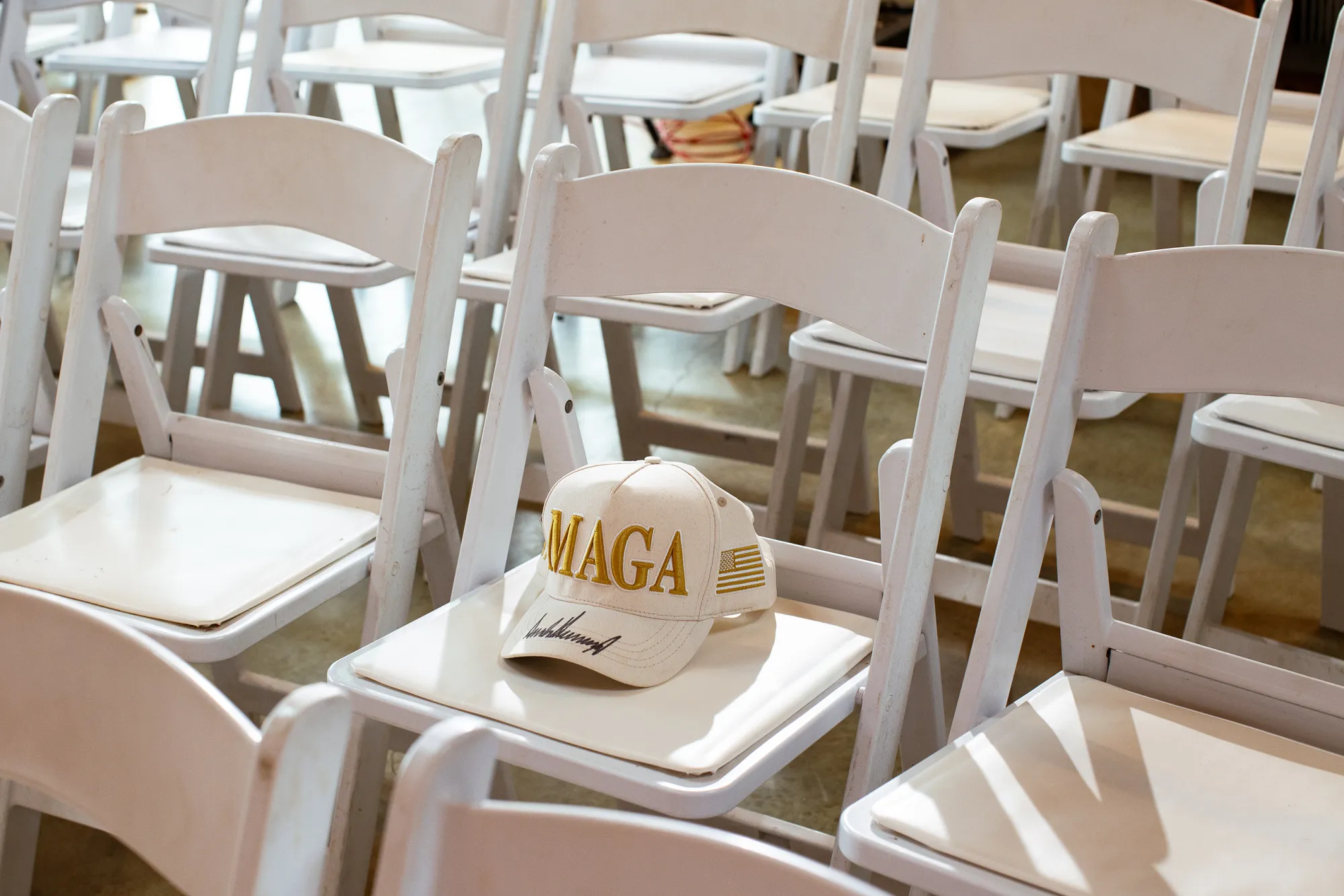 Texas businessman B. R. Israel’s MAGA hat, signed by President Donald Trump during a visit to Mara-Lago, sits on a chair before Paxton’s campaign event in Dripping Springs on Thursday.