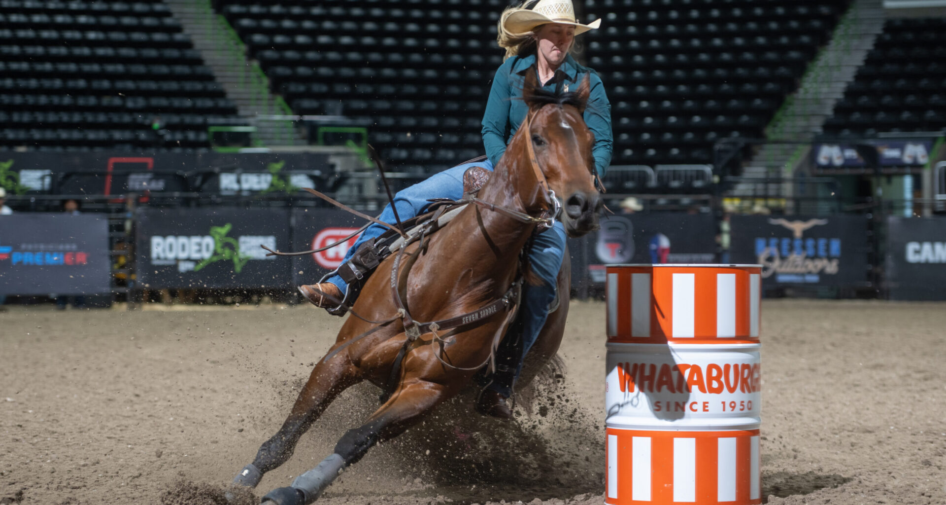 Katie Halbert turns a Whateburger barrel at Rodeo Corpus Christi on her horse