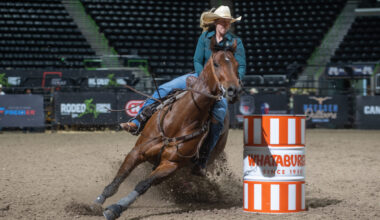 Katie Halbert turns a Whateburger barrel at Rodeo Corpus Christi on her horse