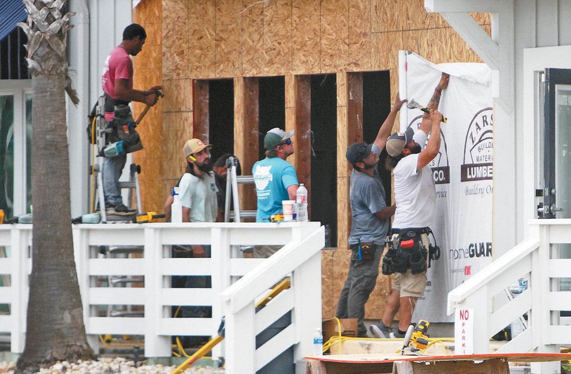 Workers toil at expanding Cita Coastal Resort Wear and Home Goods on a recent day. The project is expected to be finished by early June. Staff photo by Dan Parker