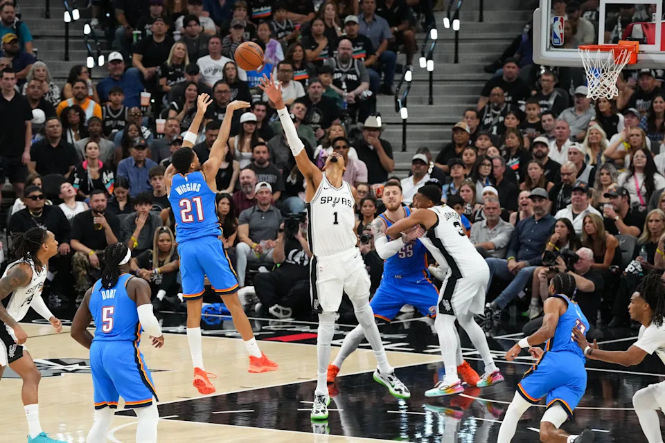 May 24, 2026; San Antonio, Texas, USA; Oklahoma City Thunder guard Aaron Wiggins (21) shoots while defended by San Antonio Spurs center Victor Wembanyama (1) in the fourth quarter during game four of the western conference finals for the 2026 NBA playoffs at Frost Bank Center. Mandatory Credit: Scott Wachter-Imagn Images