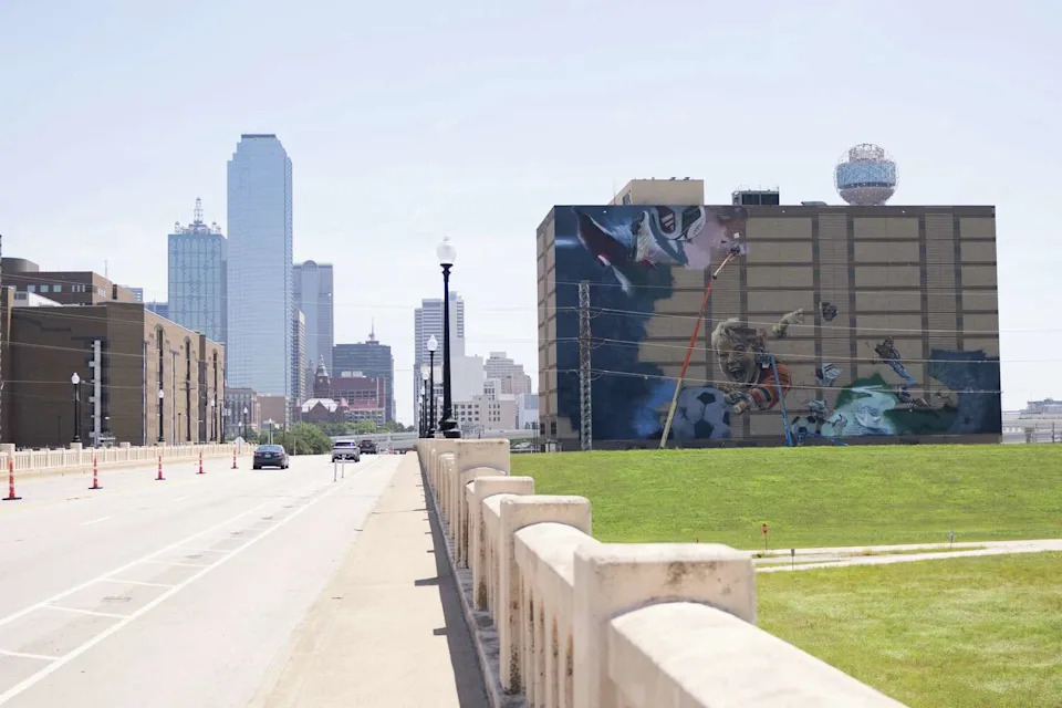 Muralists work on a soccer themed mural ahead of the 2026 FIFA World Cup on the former Jesse R. Dawson State Jail building at 106 W. Commerce Street in Dallas, Thursday, May 14, 2026. The mural will be created by internationally acclaimed artist ROOSART, curated and produced by Street Art for Mankind, and local Dallas artist Daniel Yanez. (Juan Figueroa/The Dallas Morning News)