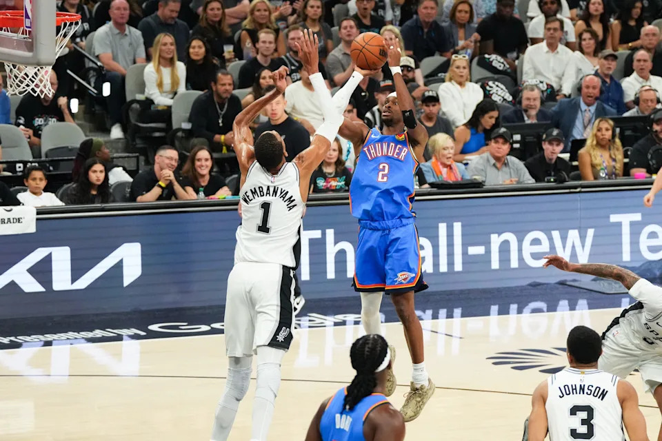 May 24, 2026; San Antonio, Texas, USA; Oklahoma City Thunder guard Shai Gilgeous-Alexander (2) shoots while defended by San Antonio Spurs center Victor Wembanyama (1) in the first quarter during game four of the western conference finals for the 2026 NBA playoffs at Frost Bank Center. Mandatory Credit: Scott Wachter-Imagn Images