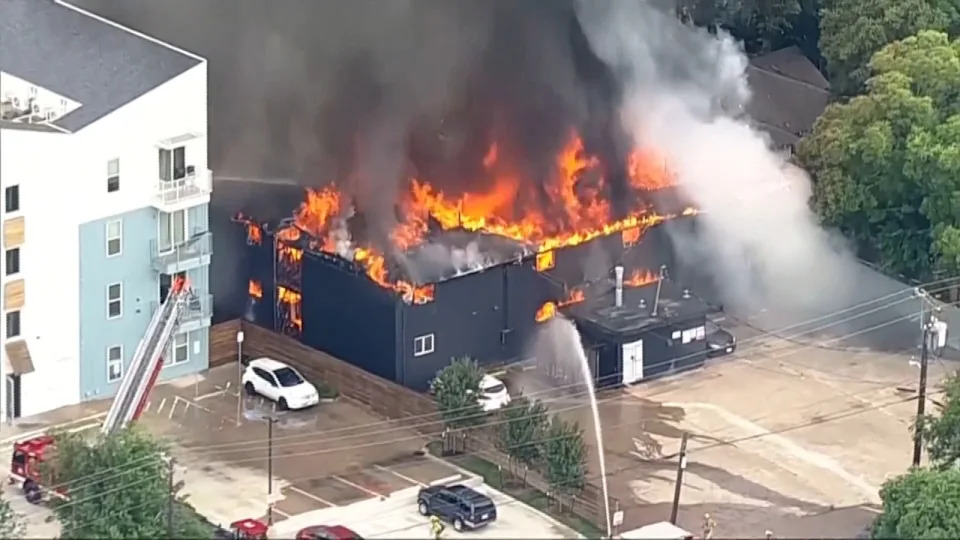 Flames engulf an apartment complex after an explosion in the Oak Cliff area of Dallas on Thursday as Dallas Fire-Rescue crews battled the blaze. Four people were hospitalized, according to reports. (KDFW FOX 4 via AP)