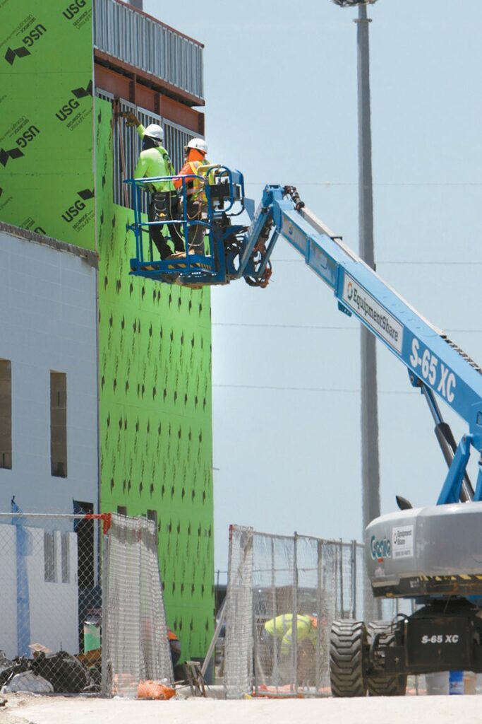Workers take a look on a recent day at one of the exterior walls at the new recreation center that’s under construction at Port Aransas Community Park. It’s one of several construction projects that the City of Port Aransas has underway. Staff photo by Dan Parker