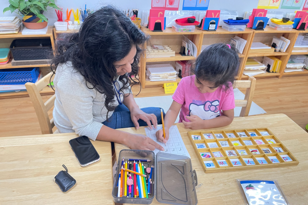 teacher working with student