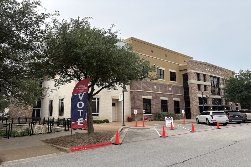 Outside Bee Cave City Hall with "vote" flag.