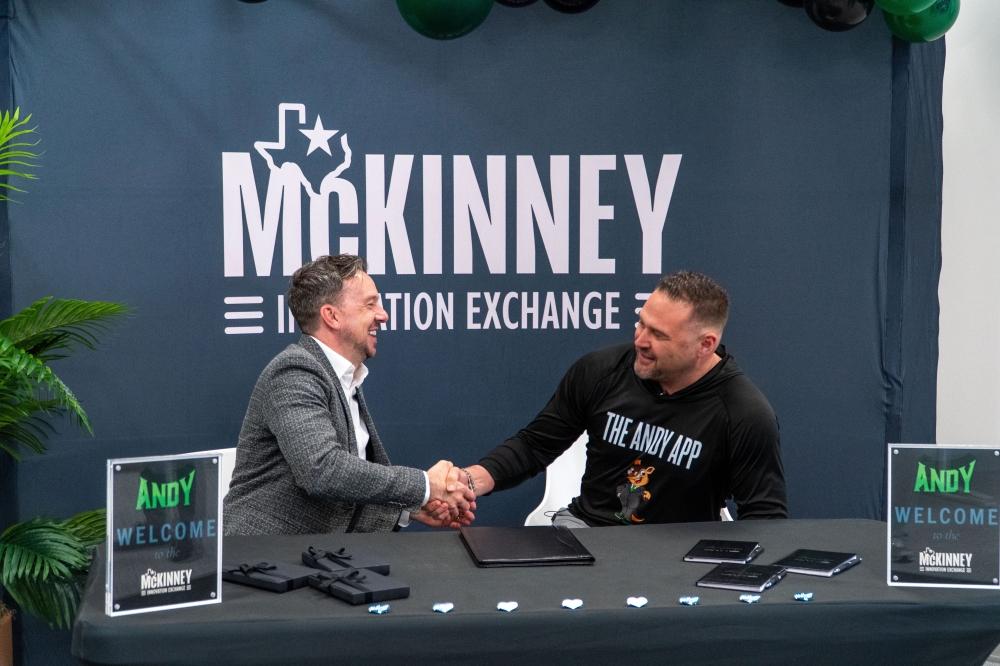 Michael Kowski, president and CEO of the McKinney Economic Development Corp. (left) shakes hands with The Andy App Founder Michael Reeves.