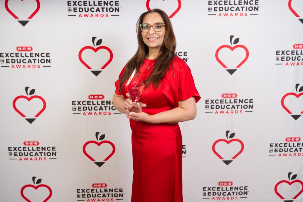 Ruth Peña, the principal of Houston ISD's Charles H. Milby High School, posing with a trophy at the 2026 H-E-B Excellence in Education Awards