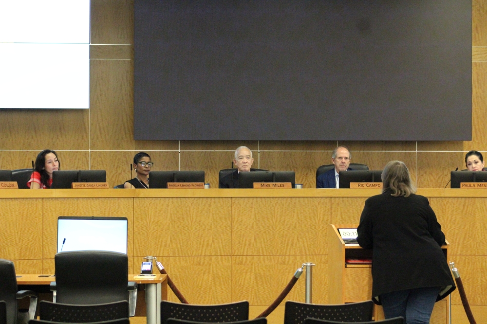 HISD board of managers sitting and listening to a speaker