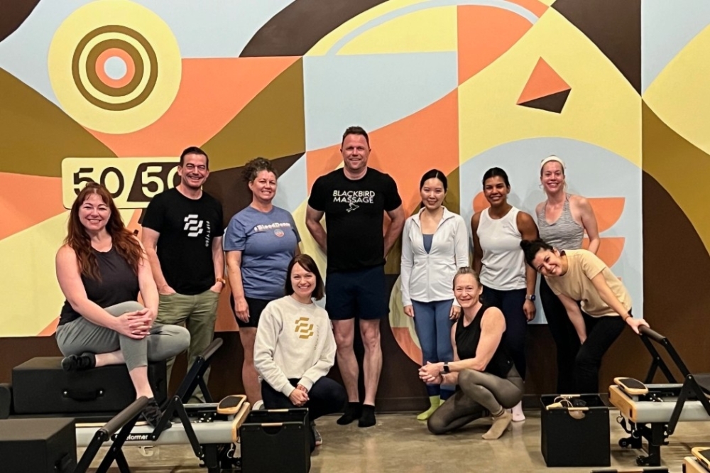 A group of people in a pilates studio.