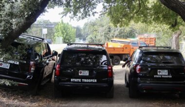 Three Texas Department of Public Safety vehicles parked near trees in Austin.